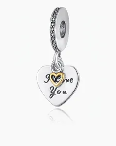 Detailed view of silver heart charm with I Love You engraving and gold heart detail