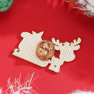 Macro shot of the gold metal backing and butterfly pin clasp on a Christmas brooch