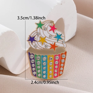 Detailed view of colorful cupcake brooch with rhinestones measuring 3.5cm by 2.4cm