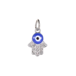 Macro view of silver Hamsa hand charm with blue evil eye and sparkling crystals