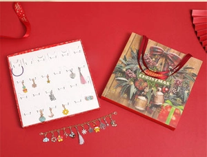 Christmas countdown jewelry advent calendar with gold bracelet and festive charms