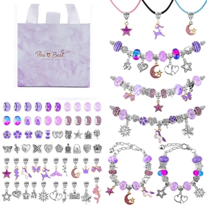 Detail view of unicorn DIY jewelry kit with charms, beads, and purple marble gift bag