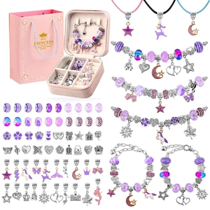 Detail of DIY unicorn bracelet kit with purple beads, silver charms, and pink gift box