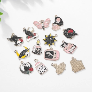 Flat lay of Gothic enamel charms including skulls and roses for DIY jewelry making