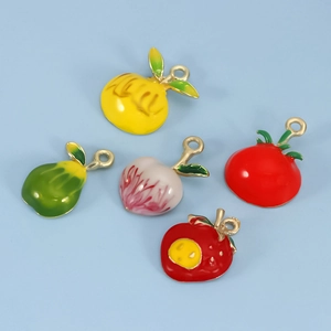Detailed view of colorful fruit enamel pendants including lemon, pear and peach for DIY jewelry