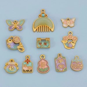 Close-up of 10 assorted Chinese enamel pendants including butterflies and fish for DIY jewelry