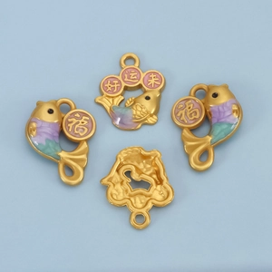 Detail of gold koi fish pendant with colorful enamel and good fortune characters