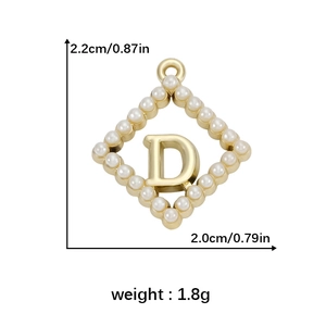 Macro view of golden D letter pendant with pearl details and 2.2cm height scale