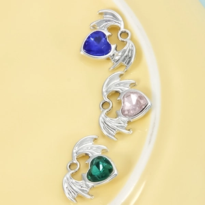 DIY winged heart charms with blue pink and green gemstones in silver metal frames