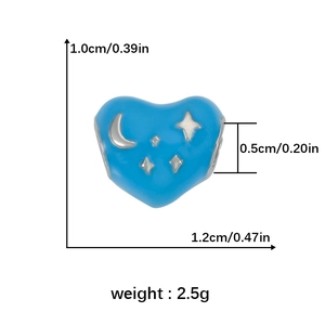 Macro view showing dimensions of blue heart charm with silver moon and star details