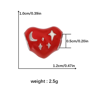 Macro shot of red heart bead with moon stars motif and dimensional specifications