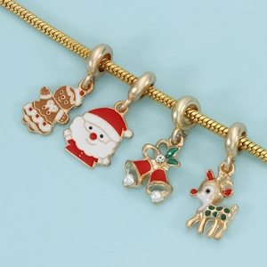 Christmas charm bracelet with gingerbread man, Santa, bells and elk on gold snake chain