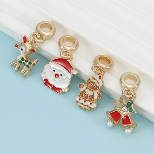 Set of 4 Christmas charms featuring reindeer, Santa, and gingerbread man with gold plating