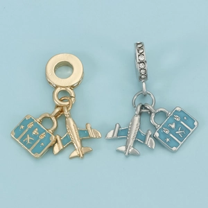 Travel themed airplane and suitcase charms with light blue enamel and sparkling crystals