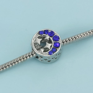 Celestial star and moon charm pendant in blue crystals on a silver snake chain bracelet