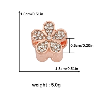 Macro detail of rose gold flower bead with cubic zirconia and 0.5cm hole size info