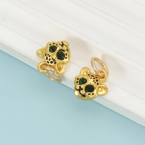 Detailed close-up of golden leopard head charms with green eyes and black enamel spots