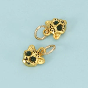 Golden leopard pendant with green gemstone eyes and black enamel details for jewelry DIY