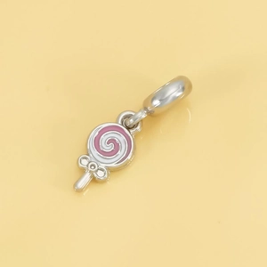 Detail of pink and white enamel lollipop charm with silver metal clasp for DIY bracelets