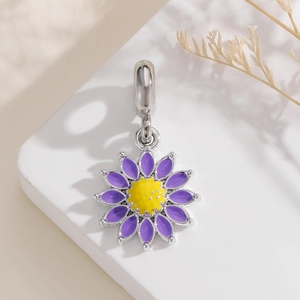 Macro shot of purple sunflower pendant with silver bail for DIY charm bracelets
