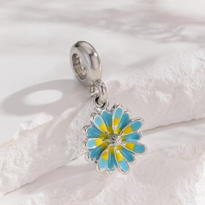 Polished silver daisy flower charm with blue enamel petals and sparkling center stone