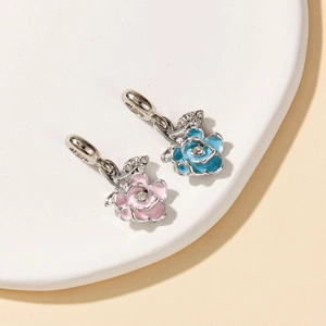 Detail of pink and blue enamel rose charms with white crystals for DIY jewelry making