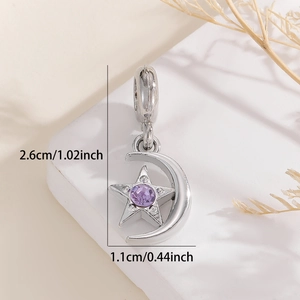 Detailed view of silver star and moon pendant with a purple zircon stone inlay