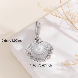 Detail of seashell charm with pearl and crystals, measuring 2.6cm by 1.7cm for DIY jewelry