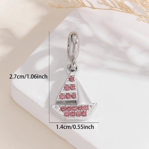 Detail of silver sailboat pendant with pink rhinestones and size dimensions 2.7x1.4cm