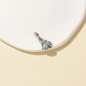 Pastoral style silver shell pendant with light blue enamel and sparkling star details