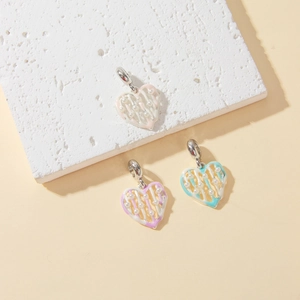 Detail of heart-shaped DIY pendants with pink, purple, and blue beads and mini pearls