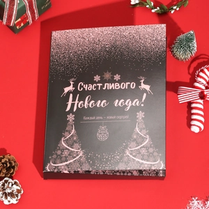 Close-up of black Christmas advent calendar box with rose gold reindeer and snowflake patterns