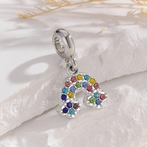 Detailed close-up of a silver rainbow charm pendant with multi-colored pavé zircon stones