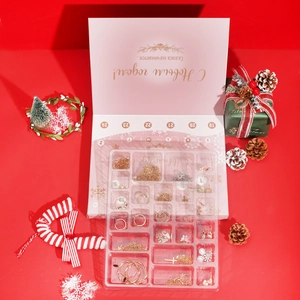 Macro view of 24-day Christmas advent calendar gift box with assorted jewelry and ornaments