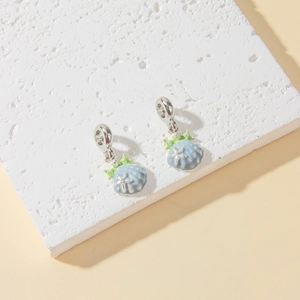Detailed close-up of blue enamel shell charms with silver starfish for DIY jewelry