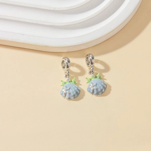 Detailed close-up of light blue shell charms with white starfish and silver ring loops