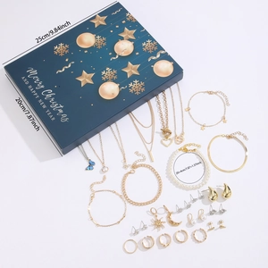 Detailed view of Christmas advent calendar jewelry box with gold necklaces and earrings