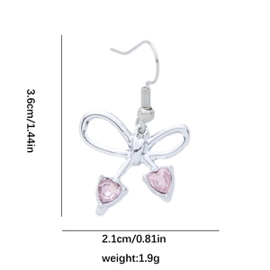 Detail view of silver bow earrings with pink heart gems including size dimensions