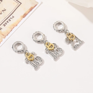 Detailed macro view of silver number 18 and 21 charms with golden heart and rhinestones