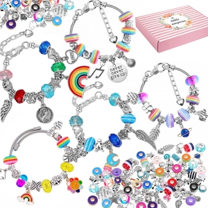 Flat lay of DIY bead jewelry set featuring colorful charms and pink striped gift box