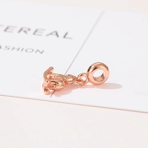 Macro shot of rose gold rocking horse charm with polished finish for DIY jewelry