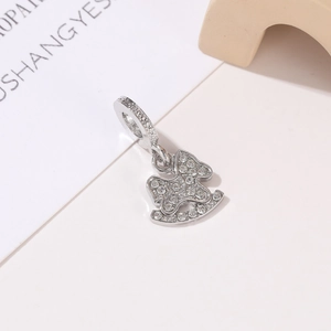 Macro detail of silver rocking horse charm with sparkling cubic zirconia pavé setting