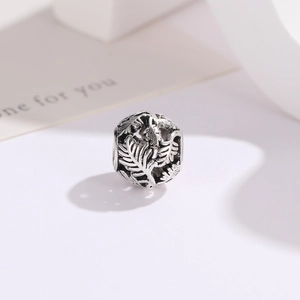 Macro shot of retro silver hollow leaf charm bead for DIY vintage jewelry making