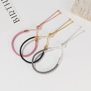 Three-piece set of woven leather cord bracelets in pink black and gray with adjustable beads