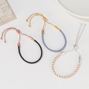 Close-up of adjustable woven leather cord bracelets with sliding metal ball clasps in three colors