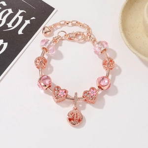 Bracciale con ciondoli in oro rosa, cuore di cristallo rosa e pendenti a fiori