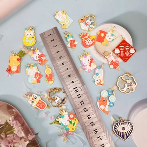 Macro shot of assorted zodiac charms with a scale ruler for size measurement reference