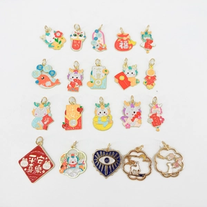 Macro shot of assorted colorful enamel DIY charms with New Year and festive motifs