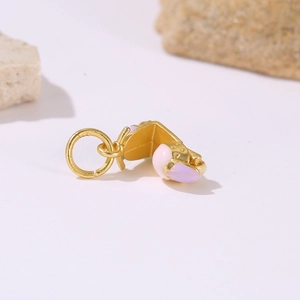 Macro detail of a gold motorcycle pendant with purple enamel for DIY jewelry making
