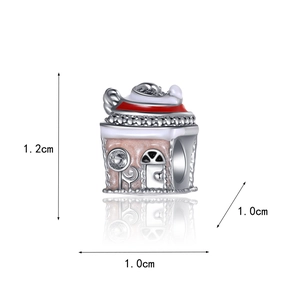 Detailed view of pink enamel gingerbread house bead for DIY bracelet jewelry